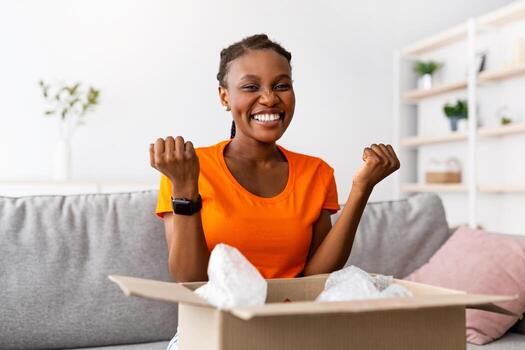 en línea compras y entrega bandera. emocionado negro mujer apertura paquete o empaquetar a hogar, haciendo si gesto, satisfecho con su ordenado producto. alegre hembra cliente recepción deseado paquete, panorama foto