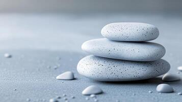 Three white rocks are stacked on top of each other on a beach photo