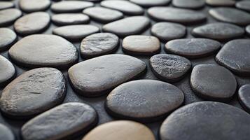 A large collection of small, grey and black stones arranged in a pattern photo