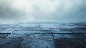A grey and blue background with a few drops of water on the ground photo