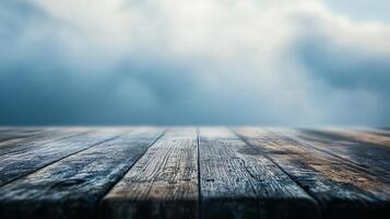 A wooden table with a cloudy sky in the background photo