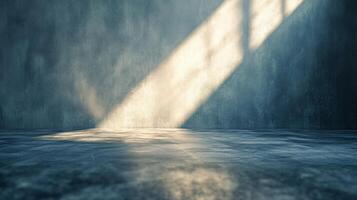 A large empty room with a window that is letting in sunlight photo