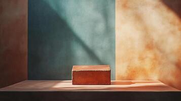 A brick structure sits on a table in front of a wall with a blue photo