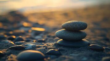 Three large rocks are stacked on top of each other on a beach photo