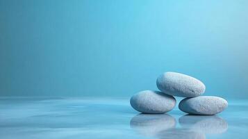Three large rocks are stacked on top of each other on a blue background photo