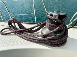 Sailing equipment with mooring rope on a yacht during a clear sunny day photo