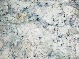 Abstract textured surface with muted colors and organic patterns photo