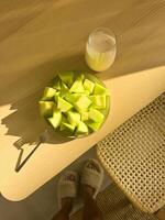 Enjoying fresh melon slices and juice in a cozy setting during the morning photo