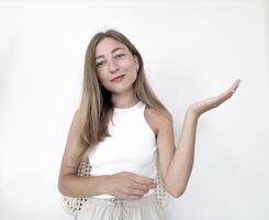 Young woman showing openness with hand gesture in bright, minimalist setting photo