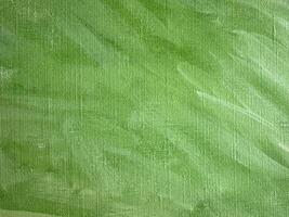Vibrant green abstract texture created with strokes of paint on canvas photo