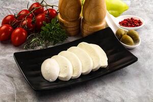 Organic mozzarella cheese slices in the plate photo