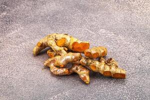 Fresh young Tumeric root heap photo
