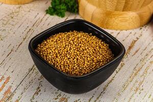 Dry mustard seeds in the bowl photo