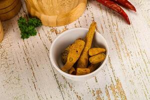Raw dry Tumeric roots heap photo