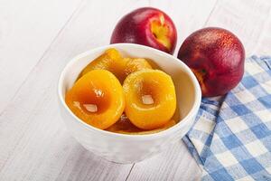 Canned peaches with sweet syrope photo