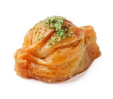 Baklava dessert with nut topping displayed on a white background photo