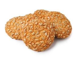 Oatmeal cookies stacked on a white surface ready to be enjoyed at a casual gathering or dessert table photo