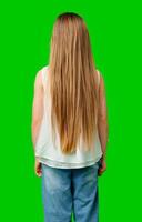 A young girl stands with her back to the viewer, showcasing her long, flowing hair photo