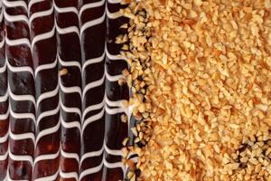 Chocolate dessert topped with crushed nuts showcases intricate design and delightful textures photo