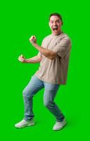 Man celebrating with a confident smile and raised fist against a bright green background photo