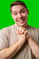 A cheerful man with a friendly smile poses against a bright green background photo