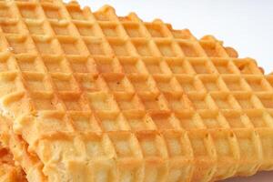 Crispy and golden waffles served on a clean white background ready to enjoy at breakfast or dessert photo
