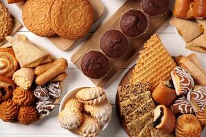 Assorted cookies and pastries displayed on wooden and ceramic trays at a dessert gathering photo