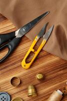 Crafting tools and materials arranged on a wooden table for sewing projects photo
