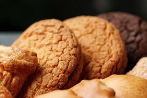 Assorted cookies displayed on a plate with various textures and colors in a warm setting photo