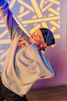 A dancer strikes a pose in a studio with colorful lighting, showcasing their fluid movements photo