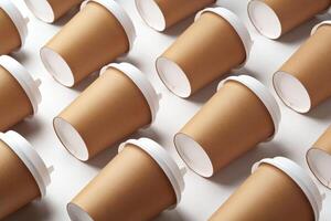 A collection of disposable paper cups arranged in a repeating pattern on a light background photo