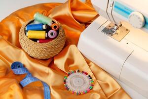 Sewing machine in use on a wooden table, stitching a light fabric in a well-lit indoor workspace photo