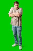 Man with a neutral expression poses against a bright green backdrop photo
