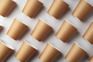 A collection of disposable paper cups arranged in a repeating pattern on a light background photo