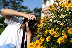 a woman photographer with a camera in her hands walks through the streets of the city photo