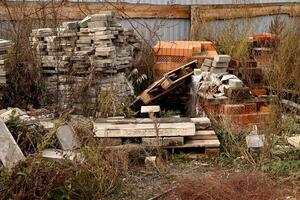 Construction waste. A pile of construction waste. Building rubble and stones. Abandoned garbage, junk, garbage piled up near the building. Street scene. Recycling industry. Ecology. Not Ecology. photo