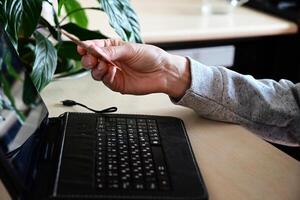 Engaging in Online Shopping With a Credit Card at a Desk Surrounded by Plants While Working From Home photo