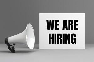 We are hiring message written on white card with a megaphone on gray background photo