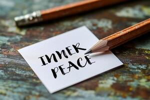 Inner peace message written on a white card with pencil. Conceptual inner peace symbol. Copy space. photo