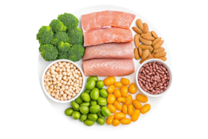 A plate filled with salmon, broccoli, almonds, and various legumes, showcasing a colorful array of nutritious foods. png