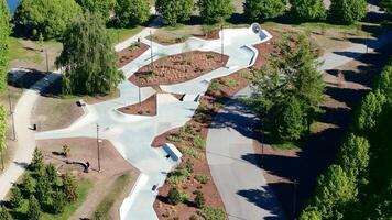Aerial View of Modern Skatepark with Concrete Paths and Ramps video