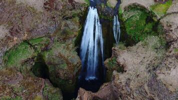 Aerial View of Icelandic Waterfall Cascading into Rocky Gorge video
