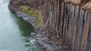Basalt Columns of Studlagil Canyon with Flowing River in Iceland video