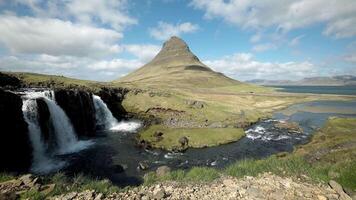 Kirkjufell Mountain and Waterfall in Iceland with Blue Sky video