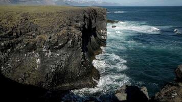 Dramatic Cliffs of Arnarstapi with Snow Capped Mountains in Iceland video