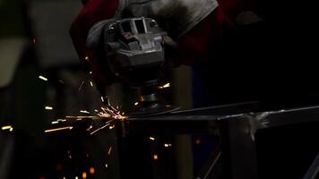 Worker Using Angle Grinder with Sparks in Industrial Setting video