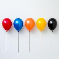 Colorful balloons in row against white background, featuring red, blue, orange, yellow, and black. Perfect for celebrations and festive occasions photo