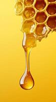 close up of honeycomb with golden drop of honey against vibrant yellow background, showcasing natural beauty and texture of honey photo