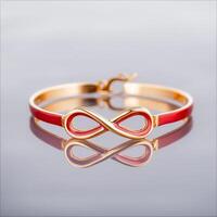 Valentine endless passion. Elegant infinity bracelet with red accents and gold finish photo
