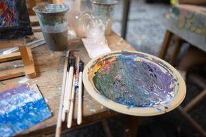 Frame canvas easel with paints palette and brushes with day light relax hobby in garden cafe class photo